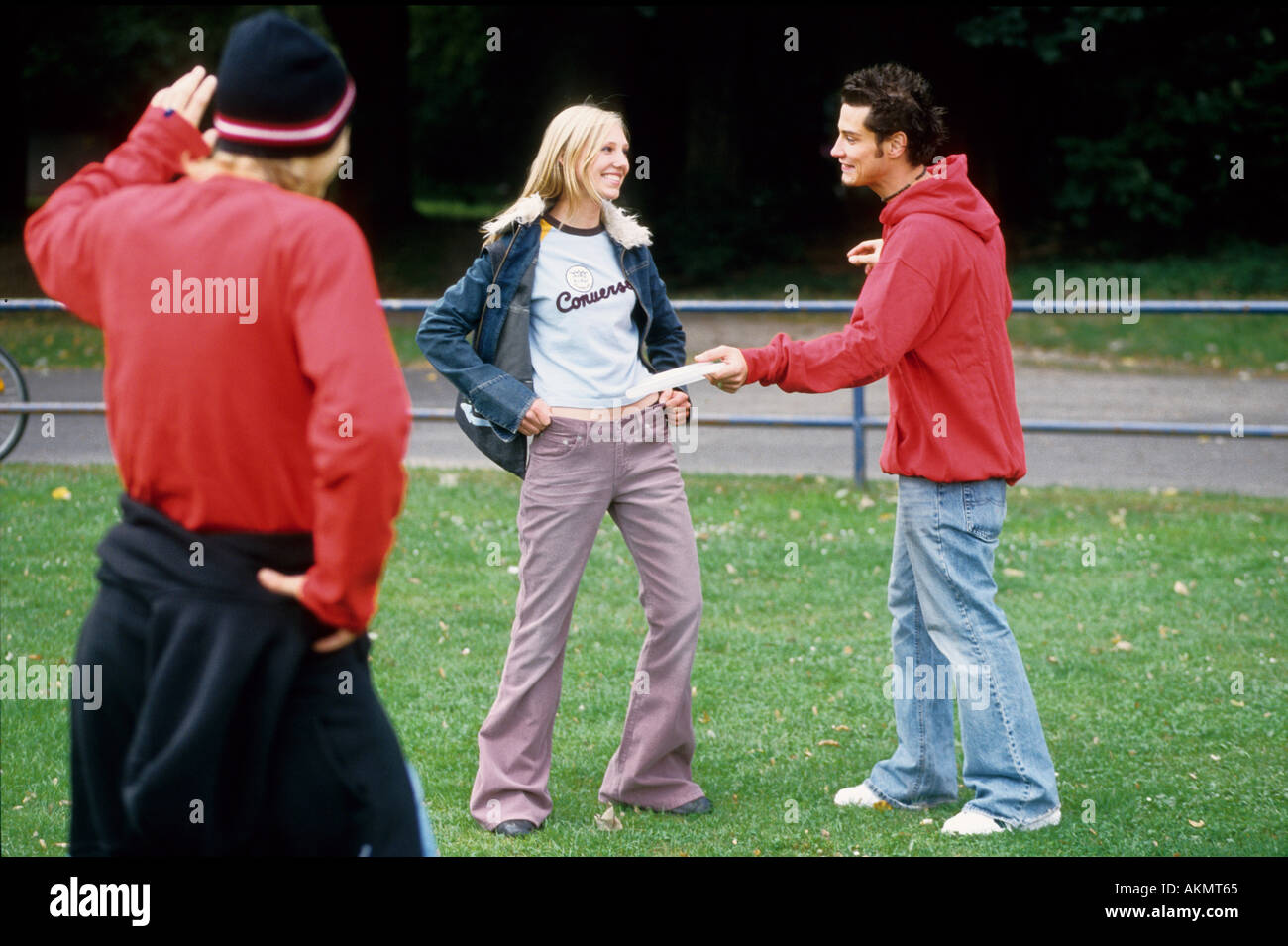 Germany Free time Three youth meeting in a park they are talking  Stock Photo
