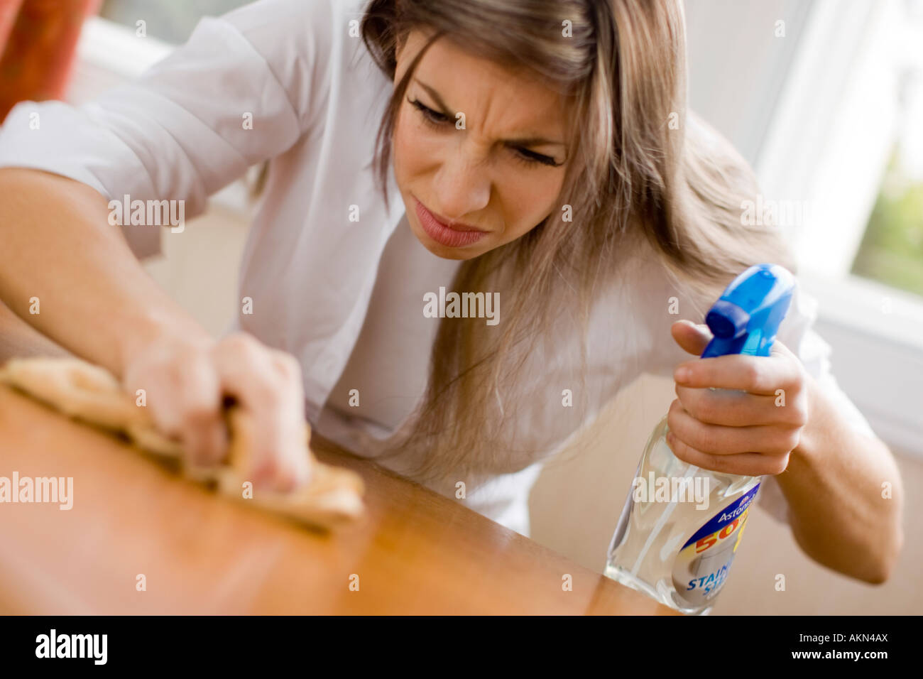Woman polishing table Stock Photo