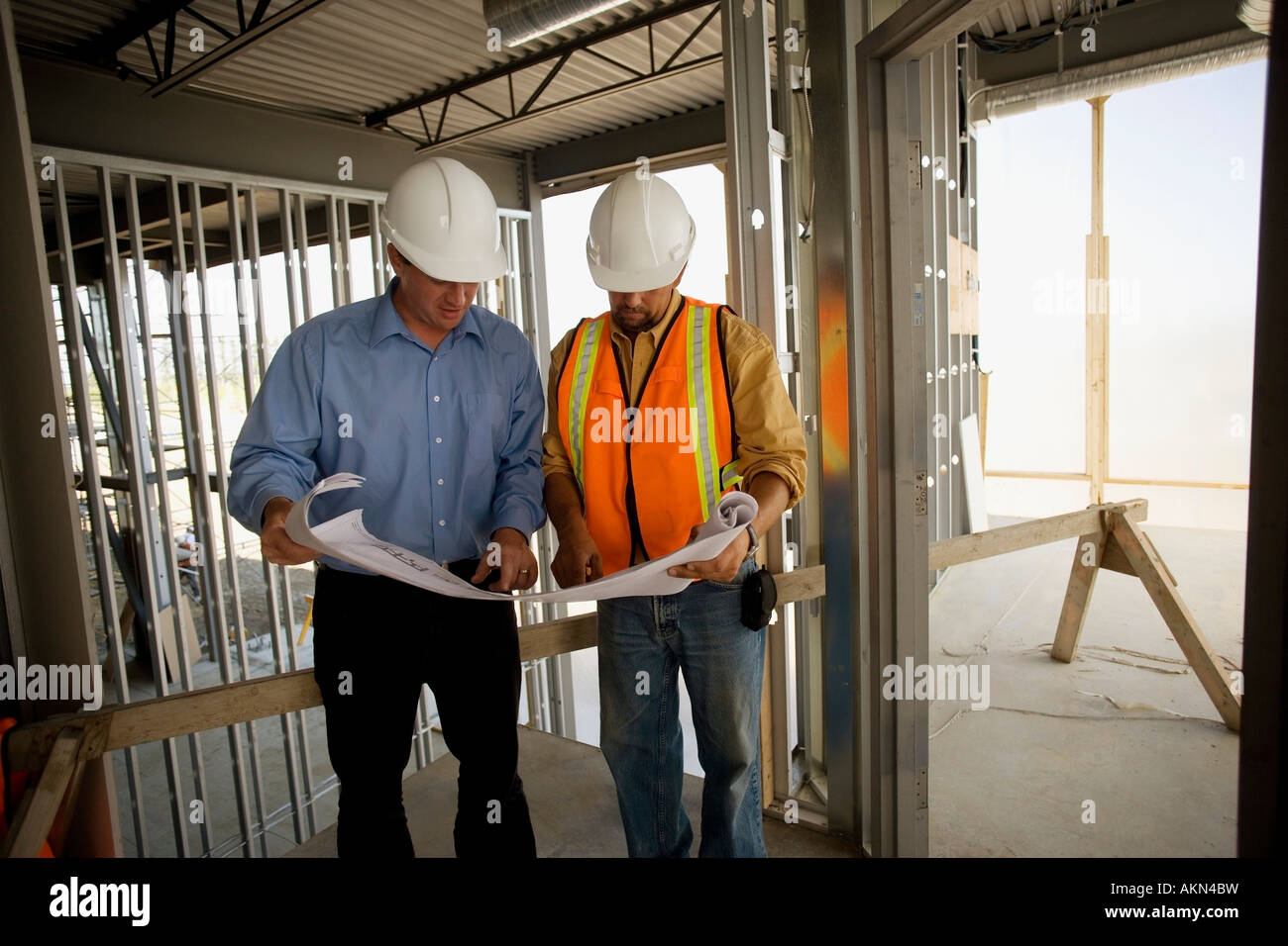 Architect consulting with construction worker Stock Photo