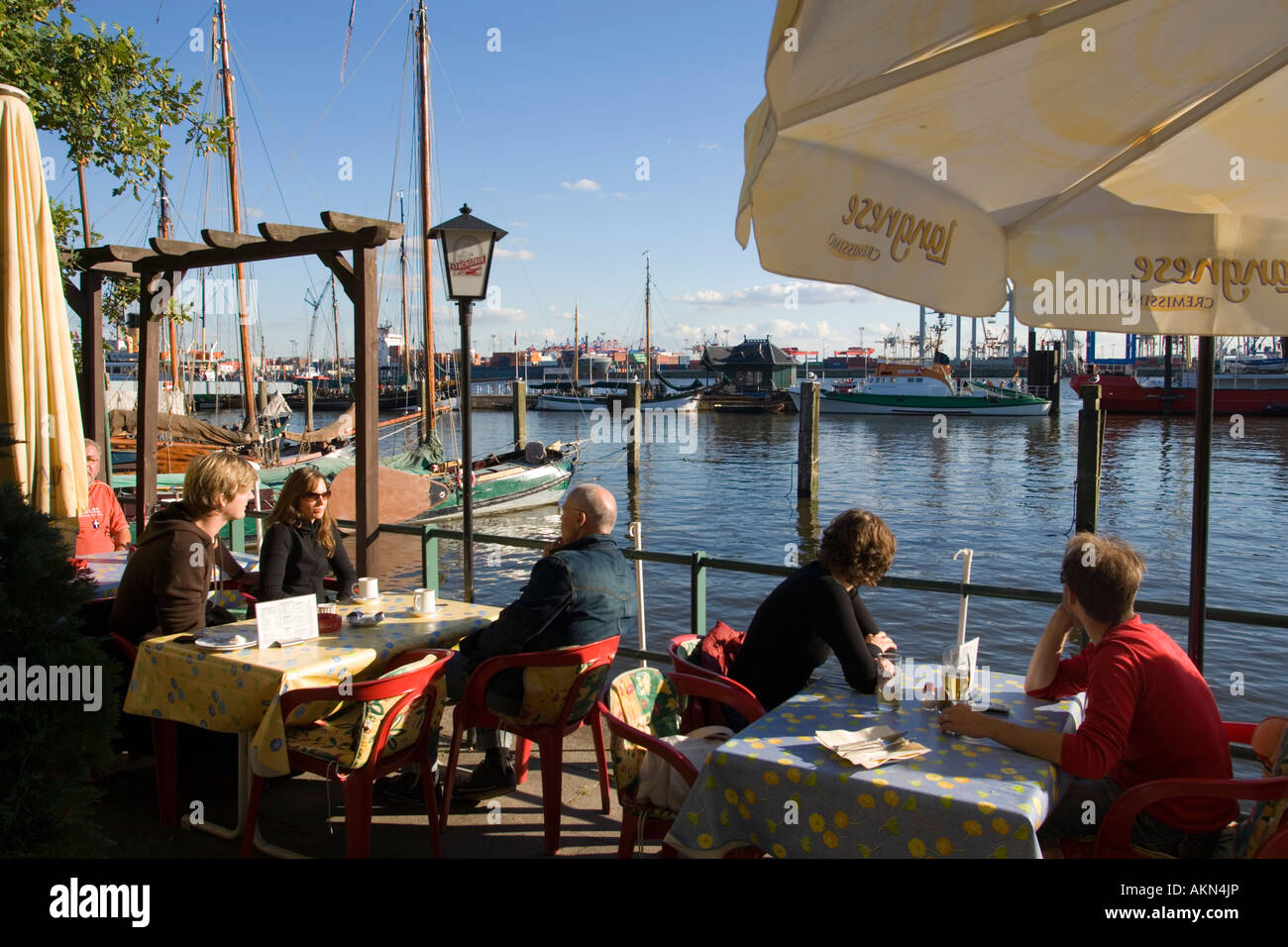 People sitting in deck chairs at sandy open air area of restaurant at Oevelg nne Hamburg Germany Stock Photo