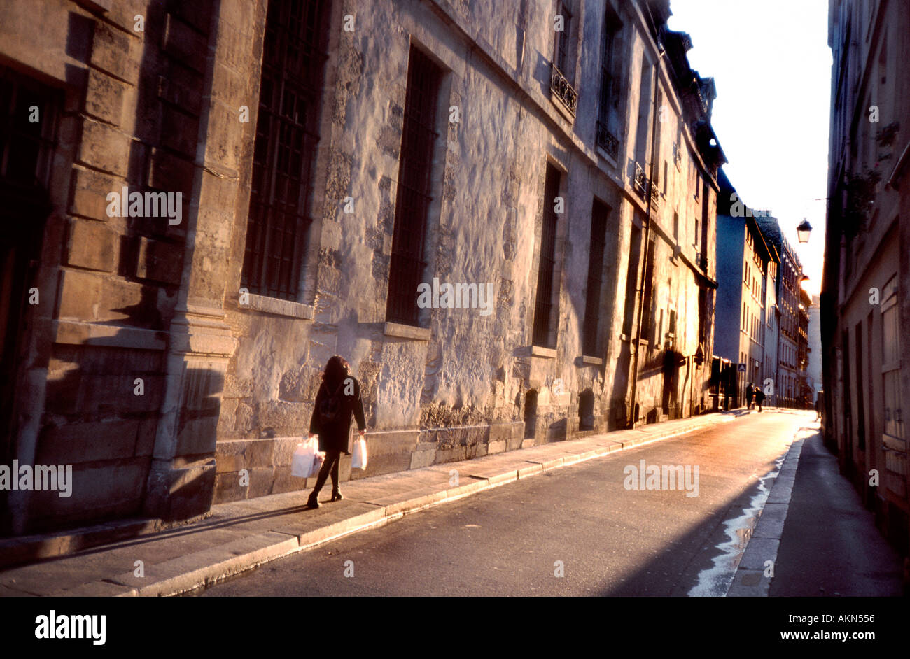 Sunlight on Buildings, Paris France, Woman Walking, Street Scene, 'Le Marais' Neighborhood, Light Effects Stock Photo