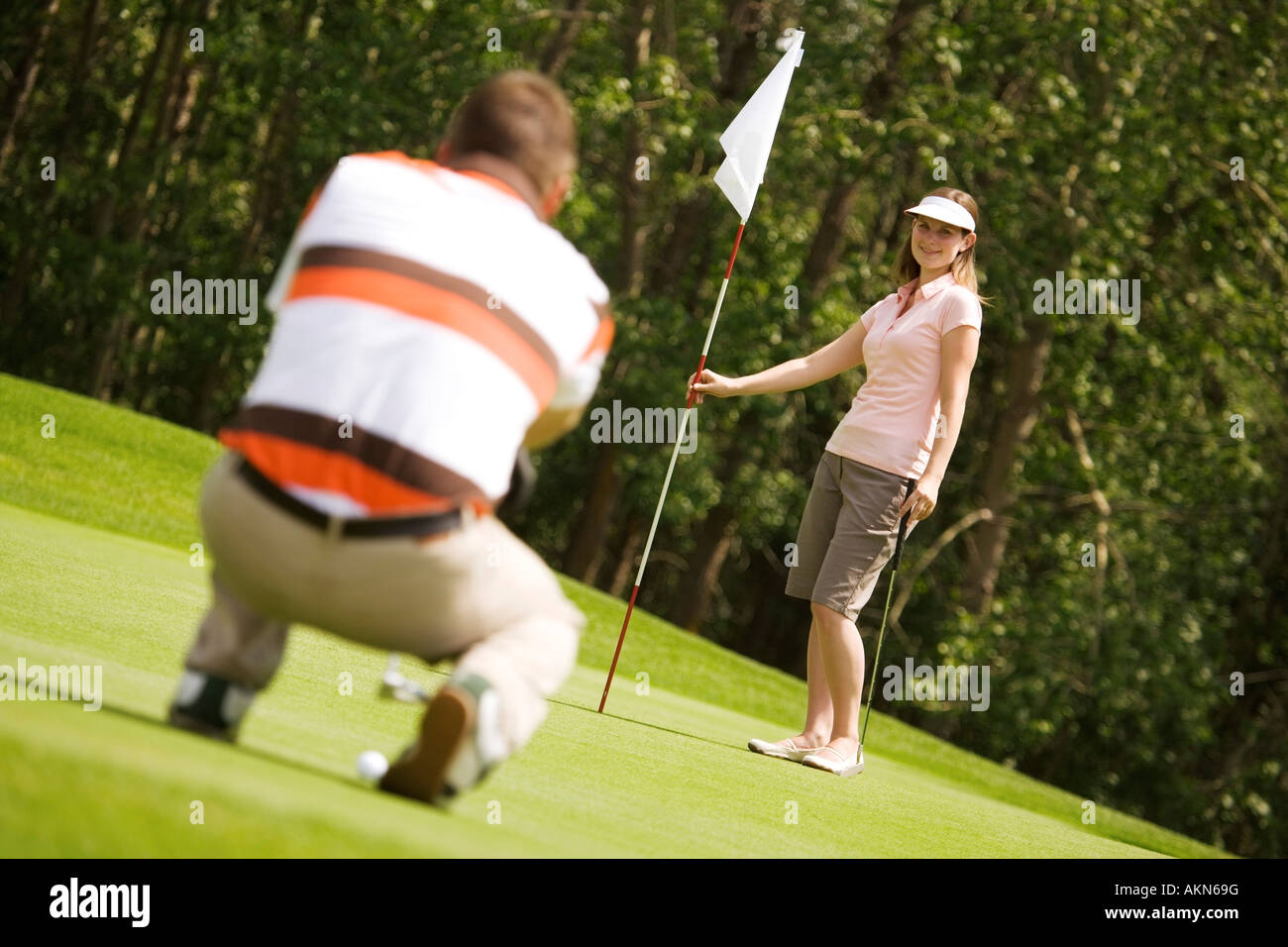 Man and woman golfing Stock Photo