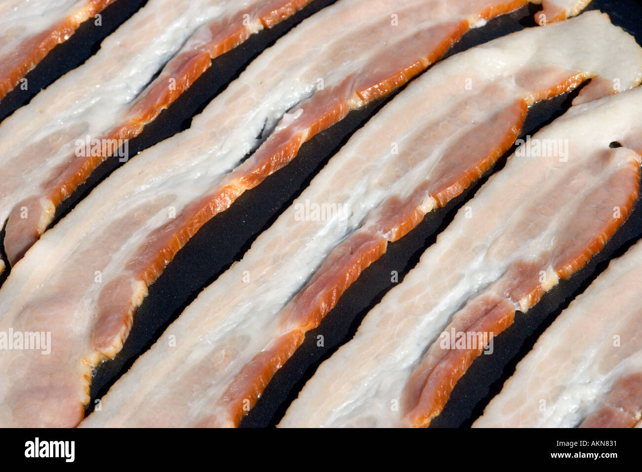 Bacon frying on an electric griddle skillet Stock Photo Alamy