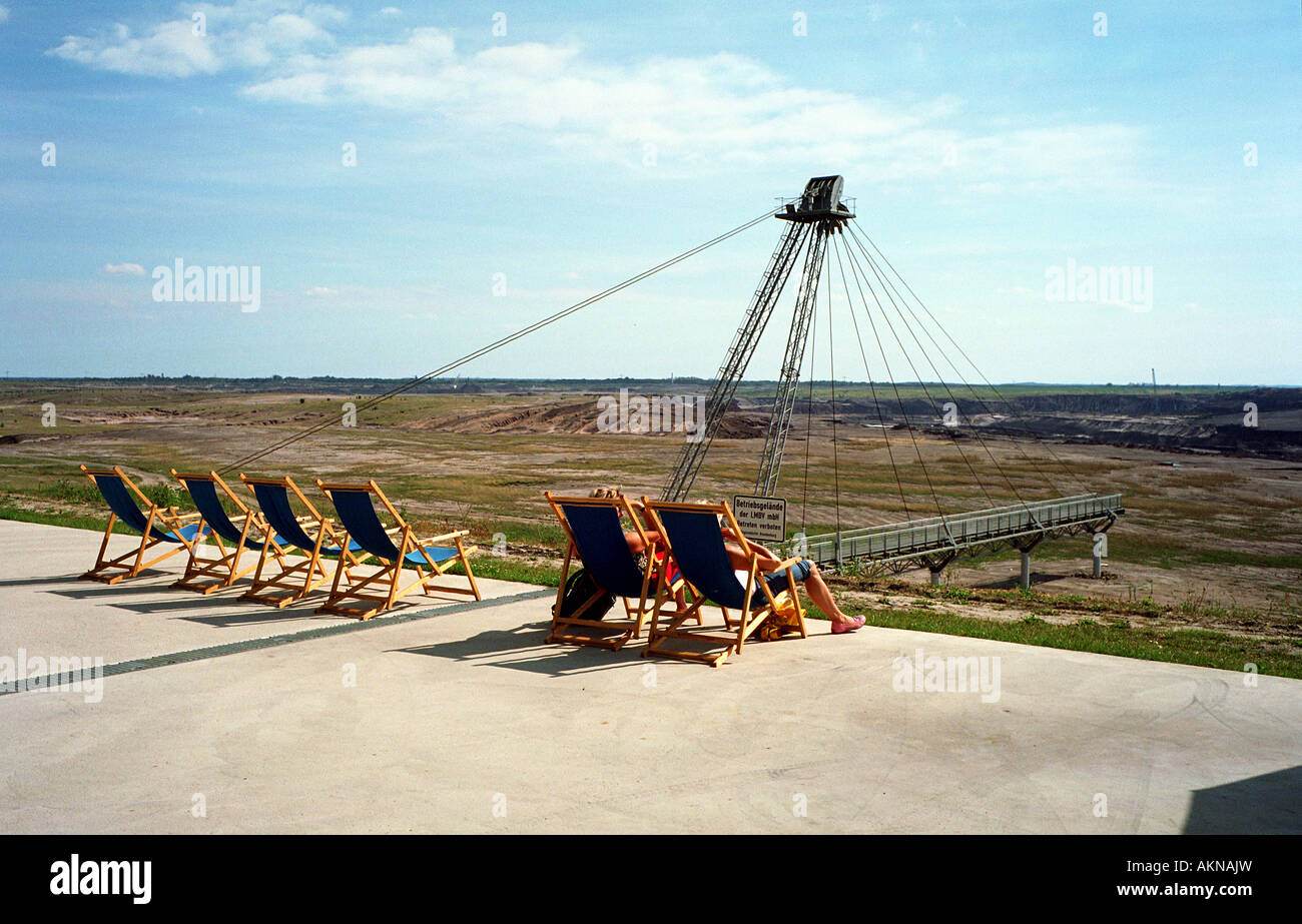 People lying on deck chairs at Ilse Lake, Germany Stock Photo