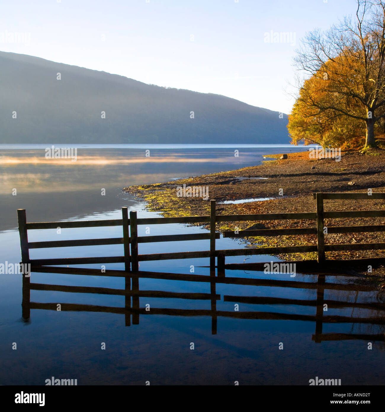 Early morning sun lighting a few wisps of mist on Coniston Water, Lake District National Park, Cumbria, UK Stock Photo
