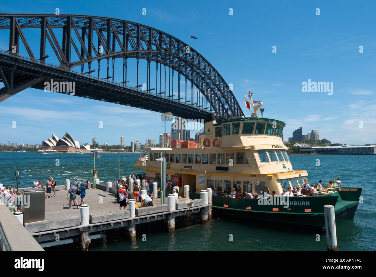 Sydney, Australia. Ferry at Milsons Point with Sydney Harbour Bridge and Opera House behind, Sydney, New South Wales, Australia Stock Photo