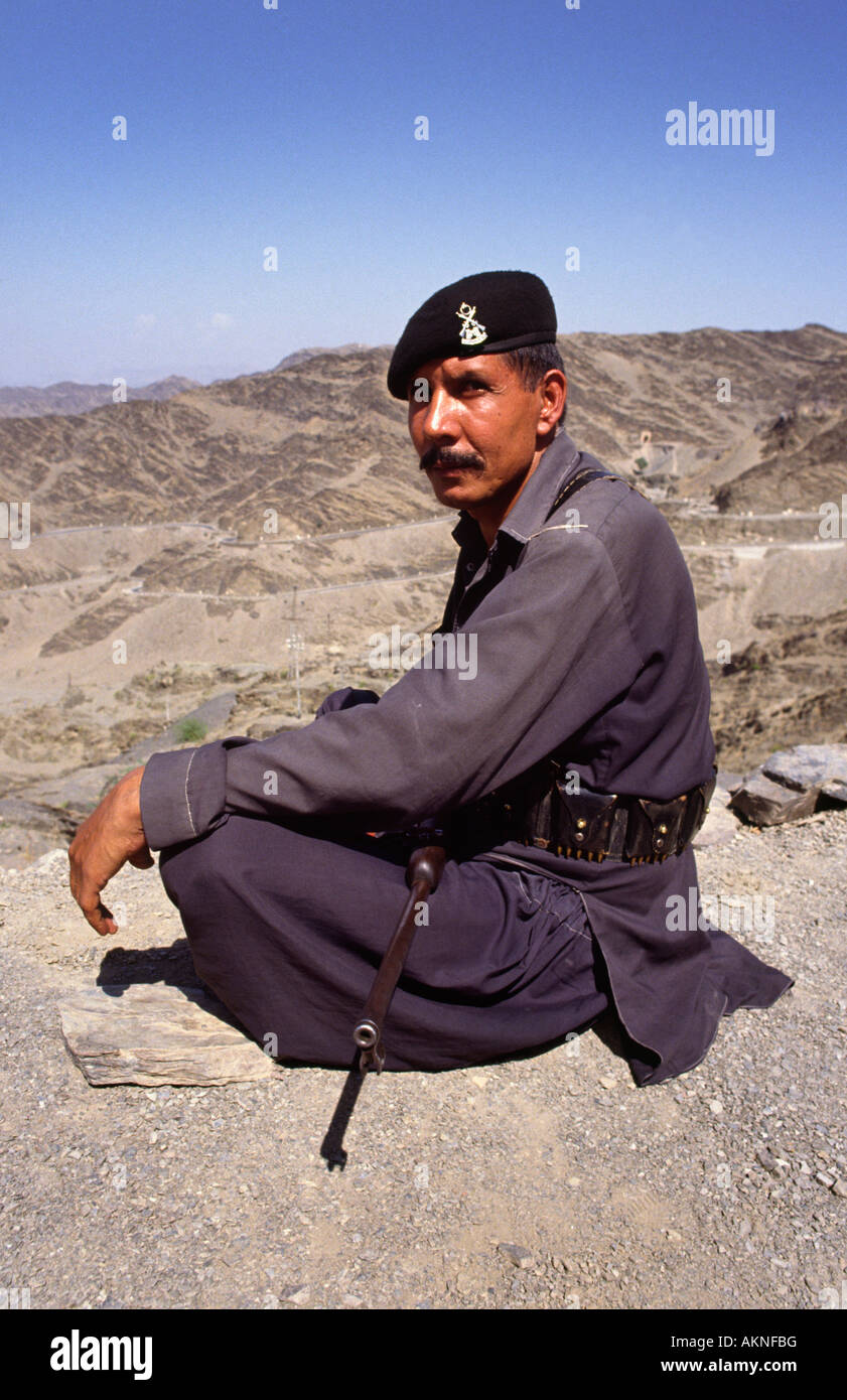 Border guard overlooking Khyber pass, gateway to Afghanistan. North Western Frontier Province, Pakistan. Stock Photo