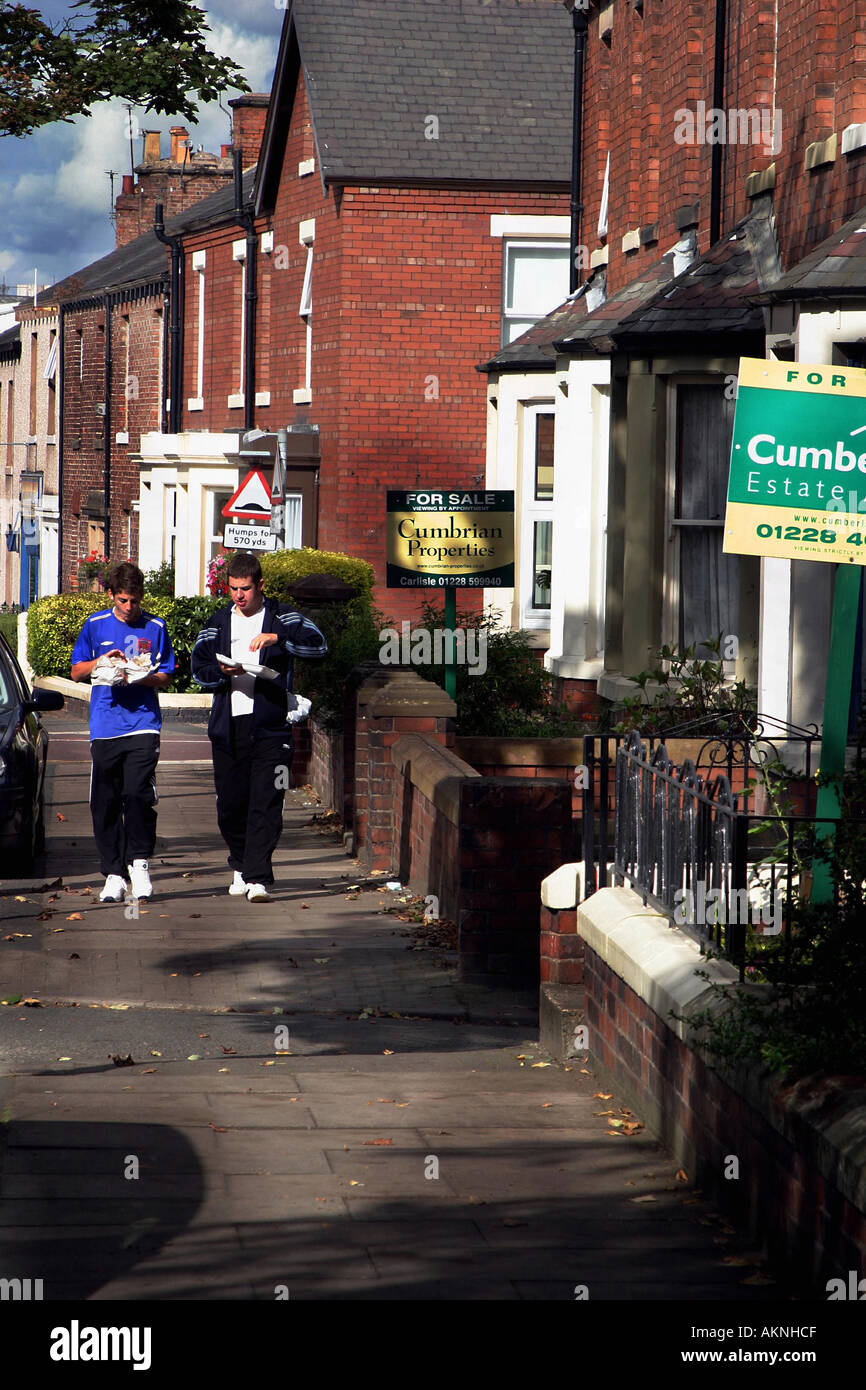 house for sale on a main street with youths walking past carlisle uk