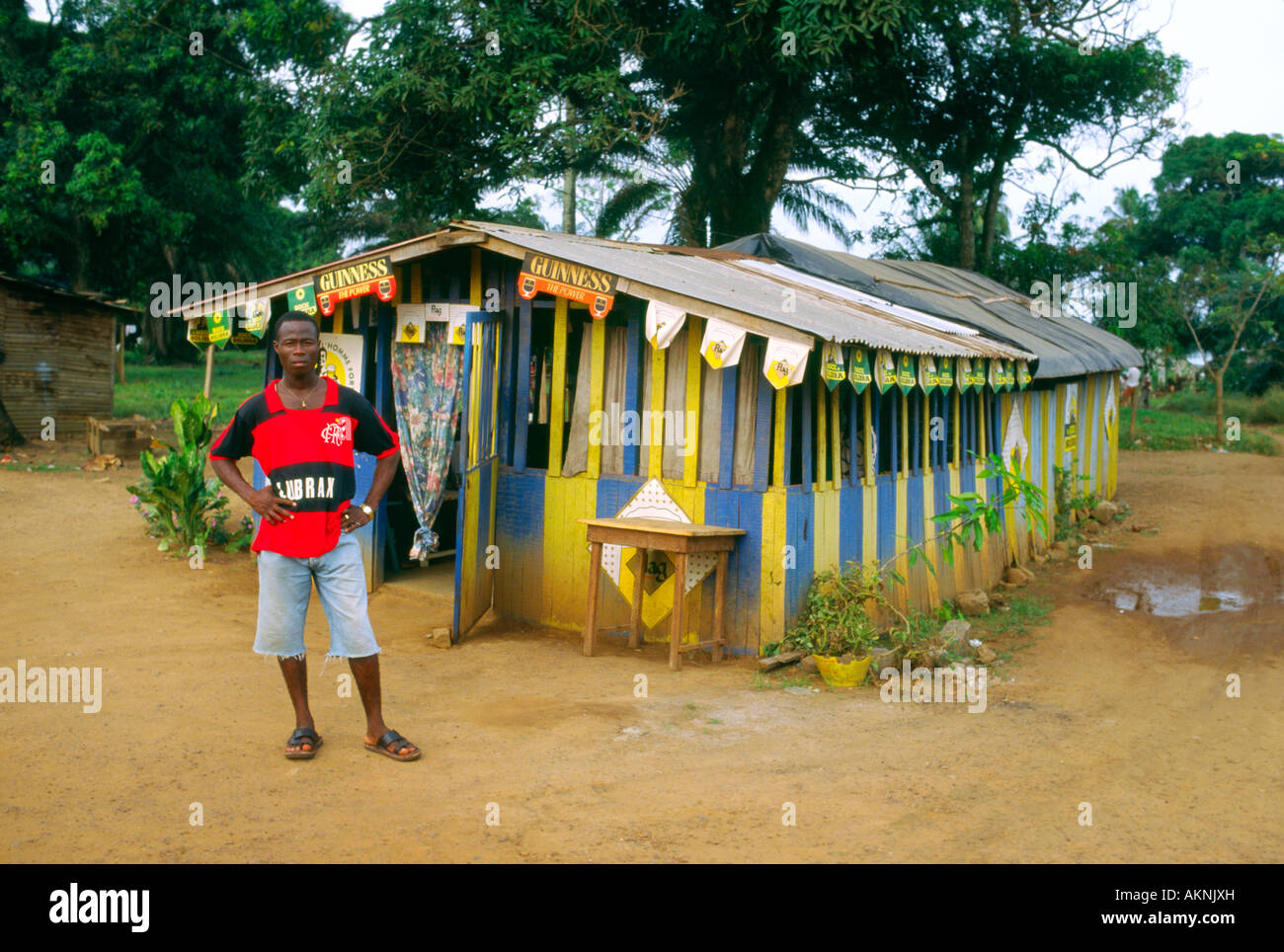 A bar owner stands outside his business Tabou Cote d'Ivoire Stock Photo
