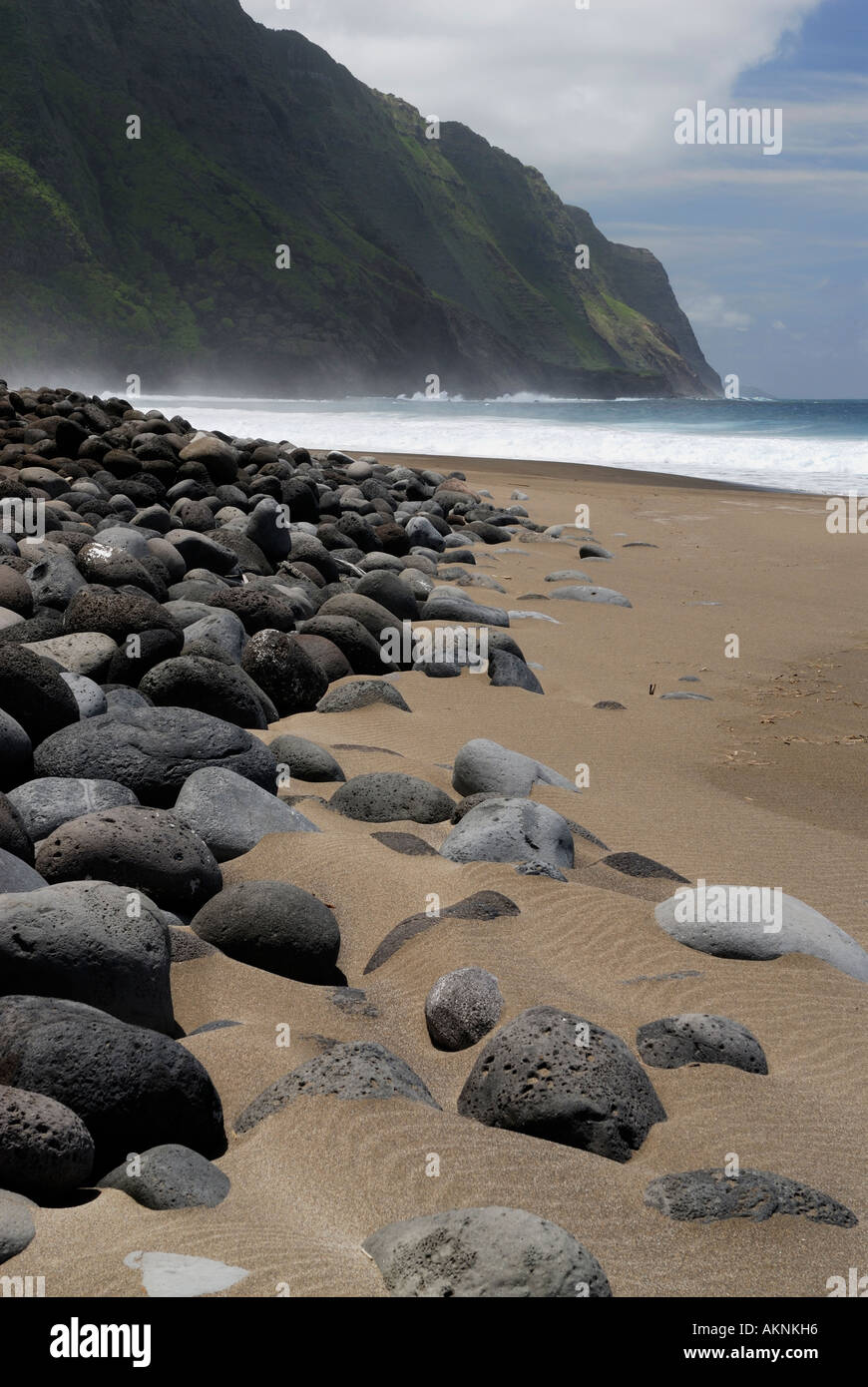Black sand beach with round smooth lava boulders at Kalaupapa leper colony Molokai Island Hawaii Stock Photo