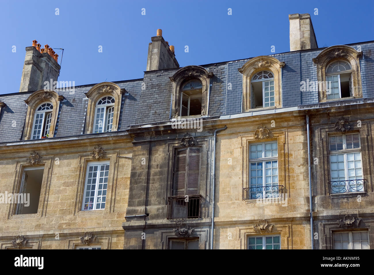 Dirt covered frontage alongside newly cleaned facades near Place de la Bourse in old  Bordeaux Stock Photo