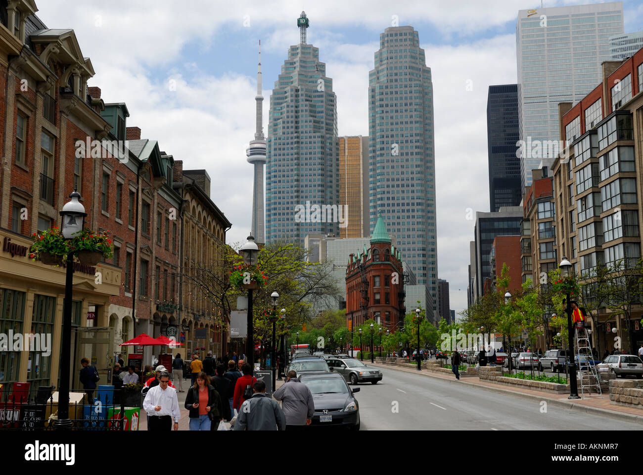 Lunch hour in Spring on Front Street Toronto with CN Tower, Wellington Flatiron building and bank high rise towers Stock Photo