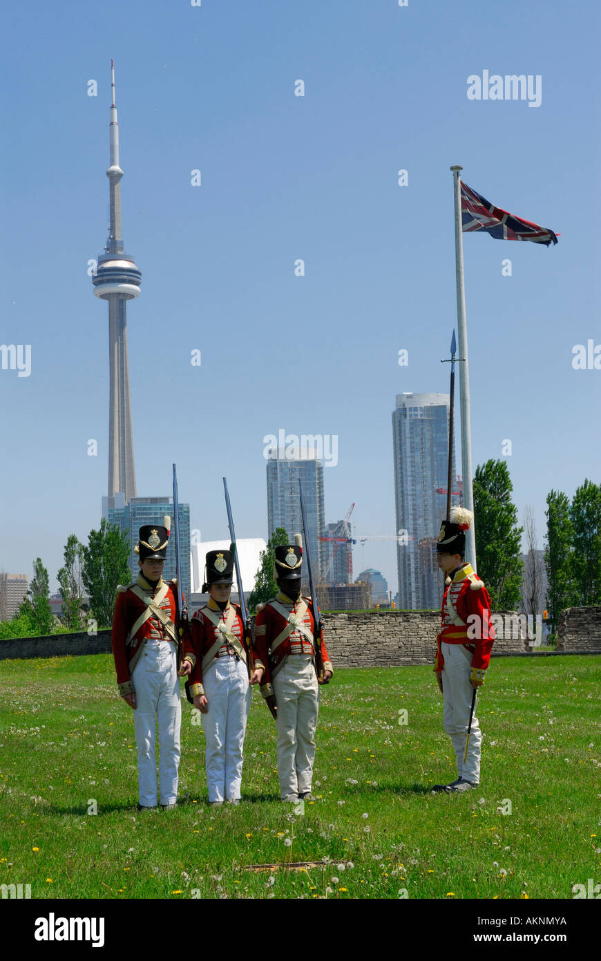 Redcoat soldiers practicing marching at Old Fort York Toronto with CN Tower and city skyline Stock Photo