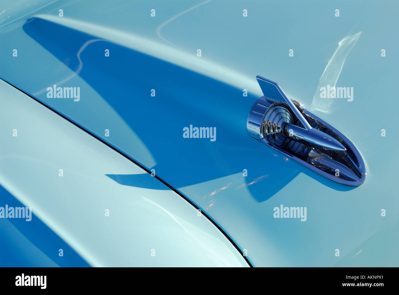 Detail of a hood ornament on a light blue 1957 Chevrolet Belair classic car Stock Photo
