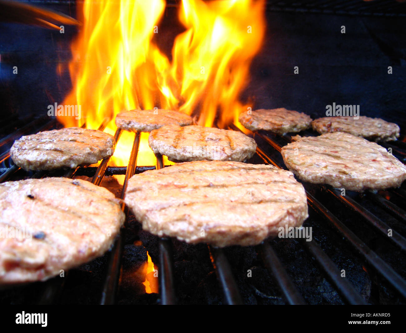 Beefburgers being flame grilled on barbecue Stock Photo - Alamy