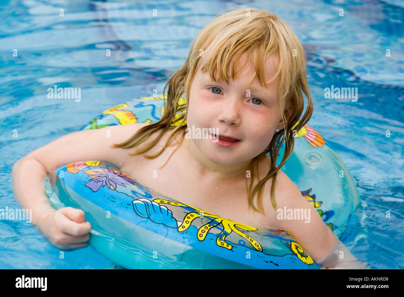 Little girl swimming in a swimming pool on holiday Stock Photo Alamy