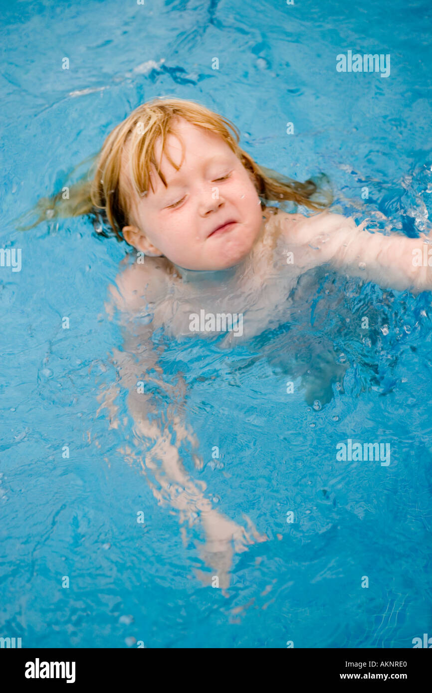 Little girl swimming in a swimming pool on holiday Stock Photo Alamy