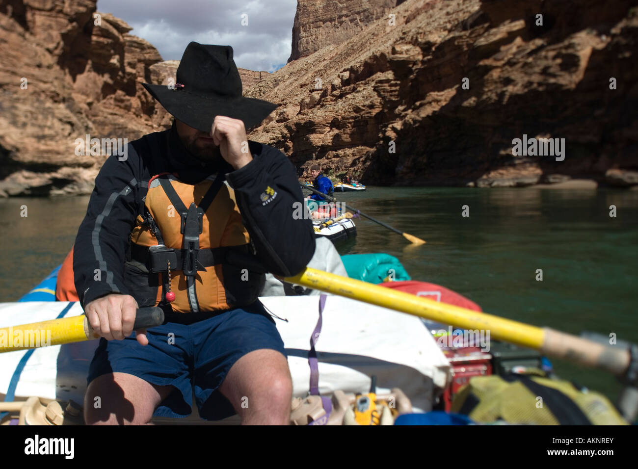 Man in cowboy hat rows raft through Grand Canyon National Park MR Stock ...