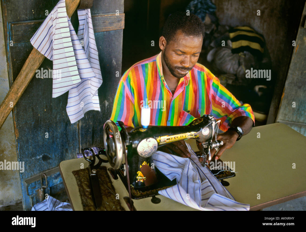 Ghanaian Woman Seamstress Using Hand Operated Sewing