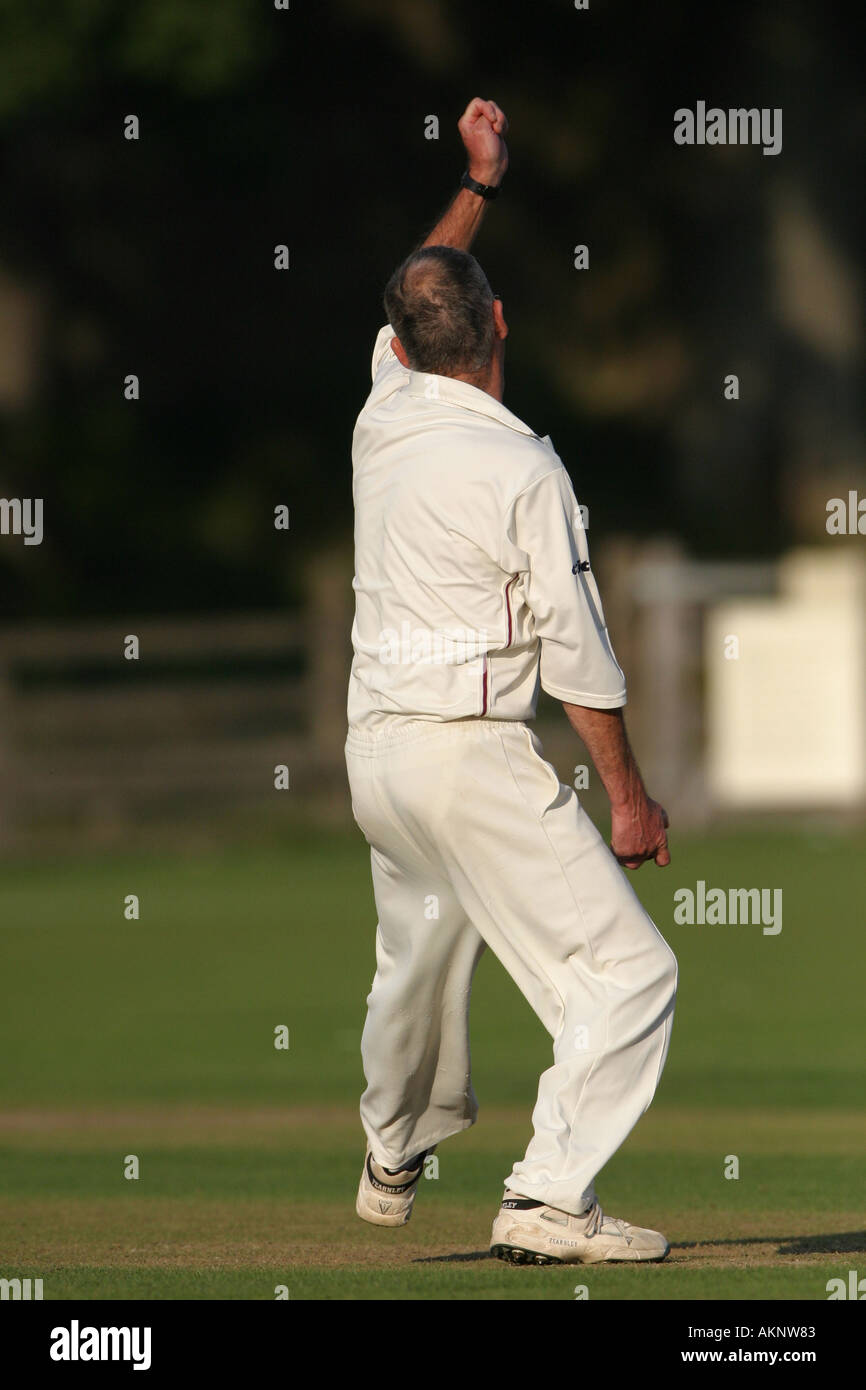 bowler bowling a ball in a village cricket game Stock Photo