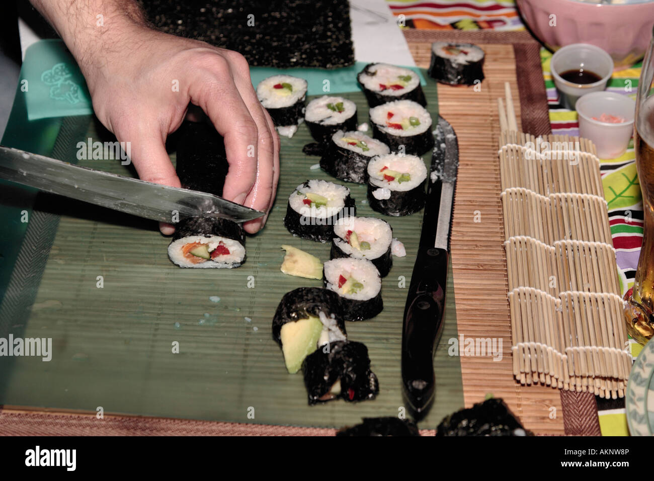 Sushi ingredients, nori seaweed on makisu bamboo mat for rolling, fresh raw  salmon, raw sushi rice, soy sauce and chopsticks on the side Stock Photo -  Alamy