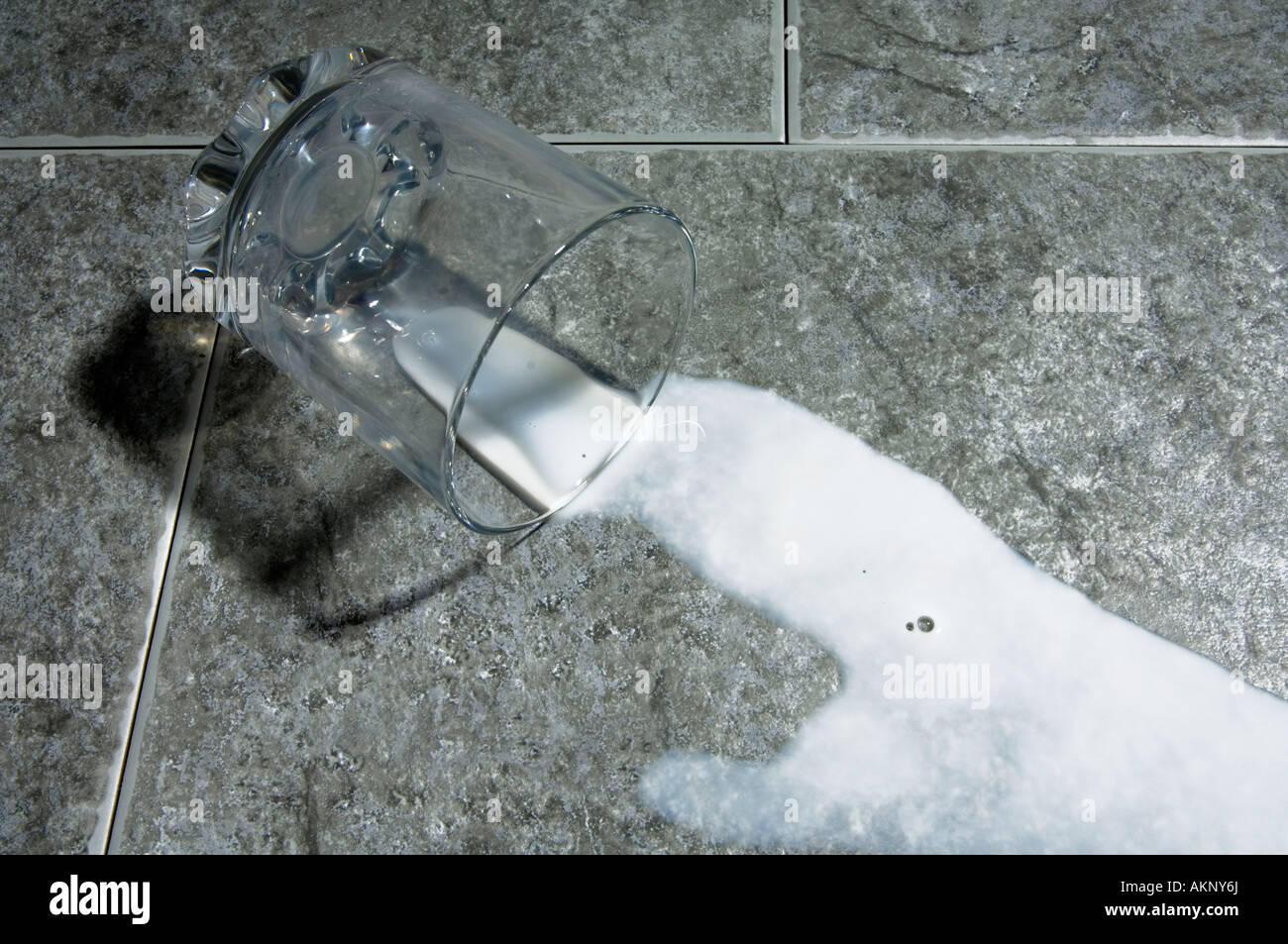 Glass of milk spilt Stock Photo