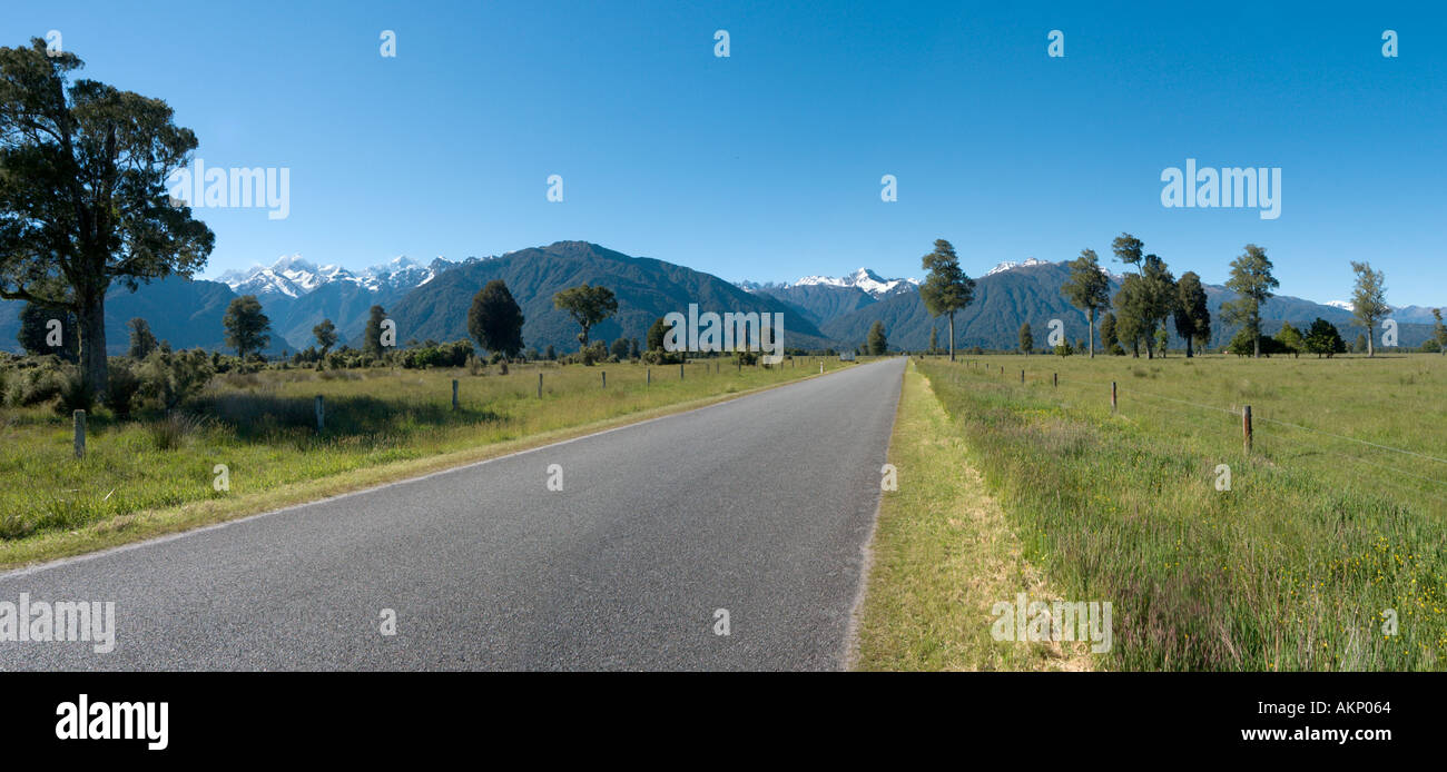 Panoramic view of road looking towards Mount Cook and Mount Tasman near Lake Matheson, Fox Glacier, South Island, New Zealand Stock Photo