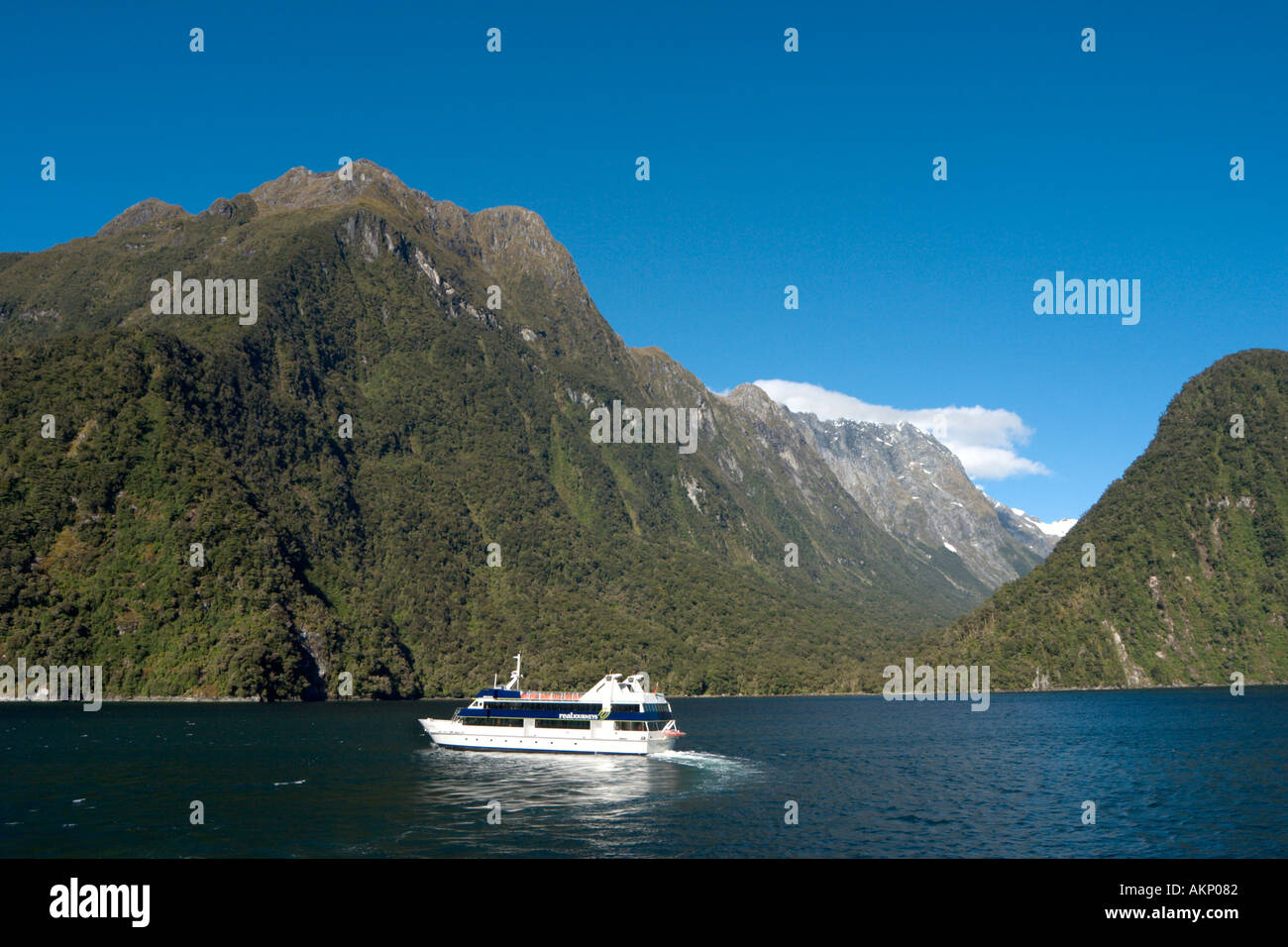 A cruise boat on Milford Sound, Fiordland National Park, South Island, New Zealand Stock Photo
