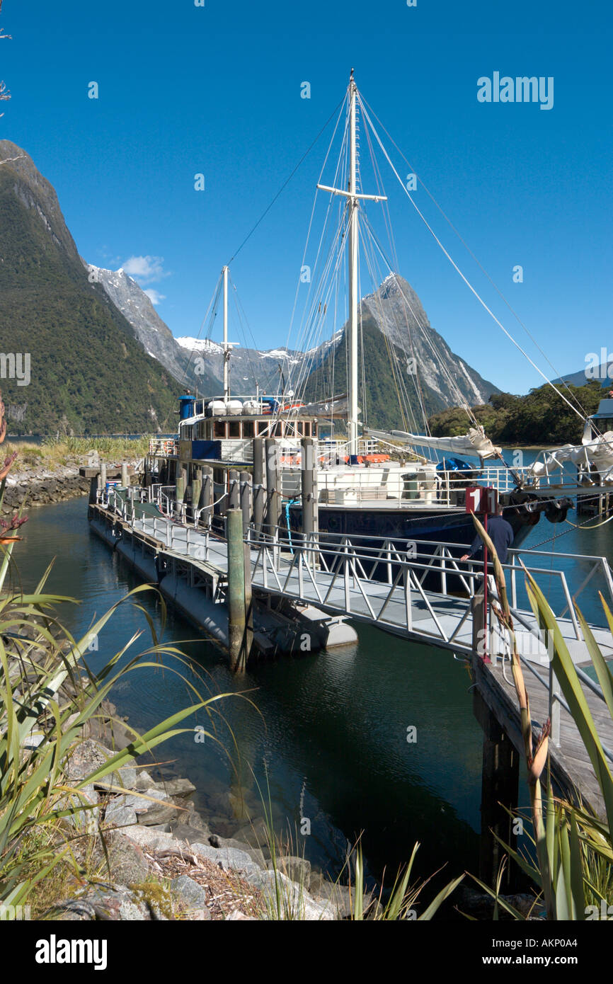 Cruise Boat with Mitre Peak behind, Milford Sound, Fiordland National Park, South Island, New Zealand Stock Photo