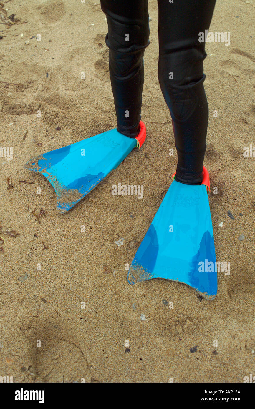 flippers and wet suit sandy beach Stock Photo
