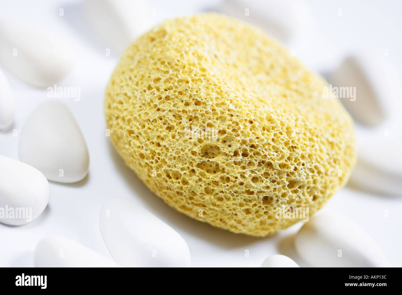 Yellow bath sponge with aromatherapy pebbles Stock Photo Alamy