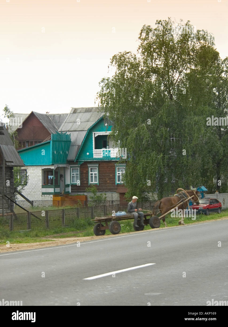 Horse and cart on main road with Dutch style houses behind in Belarus Stock Photo