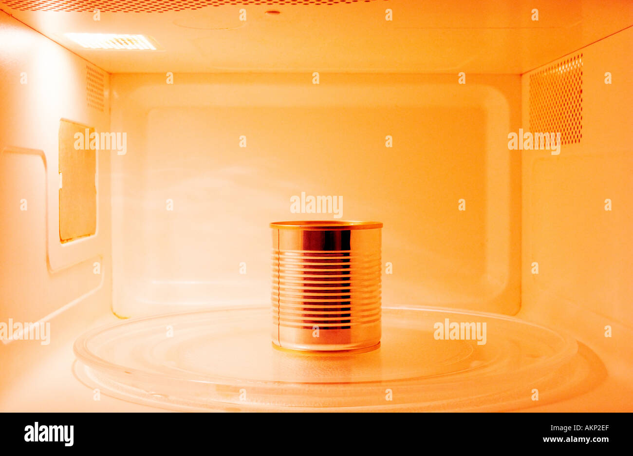 One food tin can inside an opened microwave Stock Photo Alamy