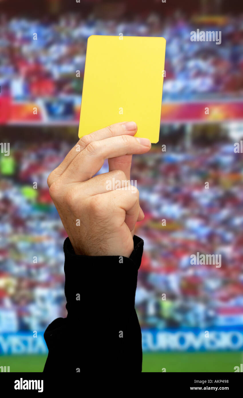 referee holding up a yellow card Stock Photo