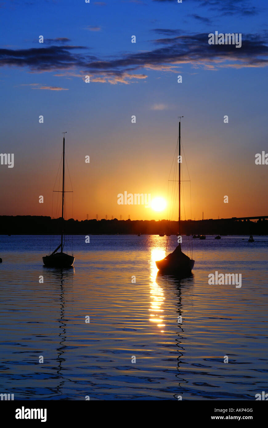 Sailing Boats reflection in the sunset Stock Photo - Alamy