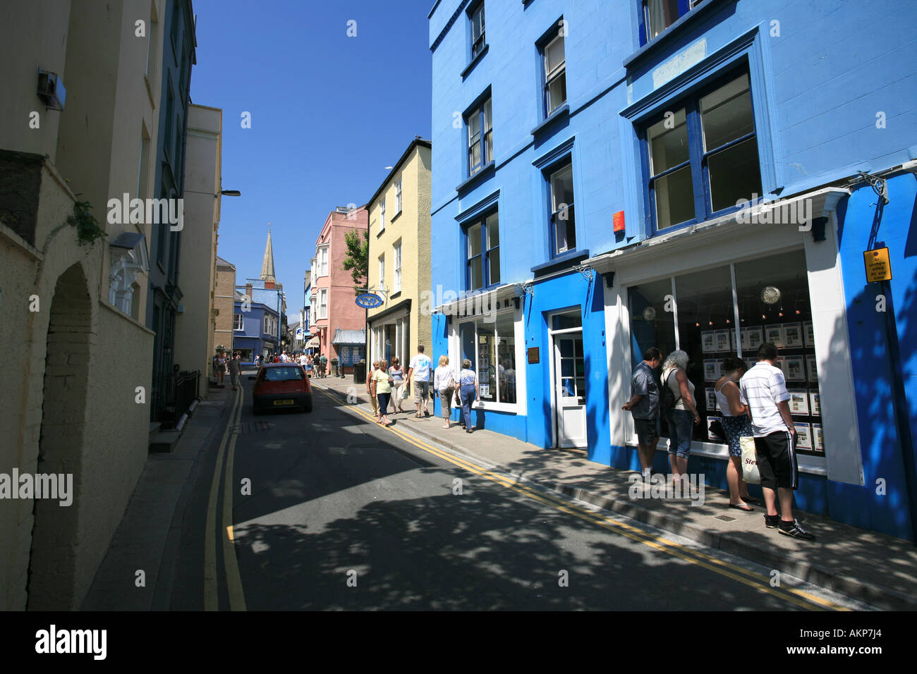 Tenby town centre with tourists exploring the small shops boutiques and cafes West Wales Uk Britain Europe Stock Photo