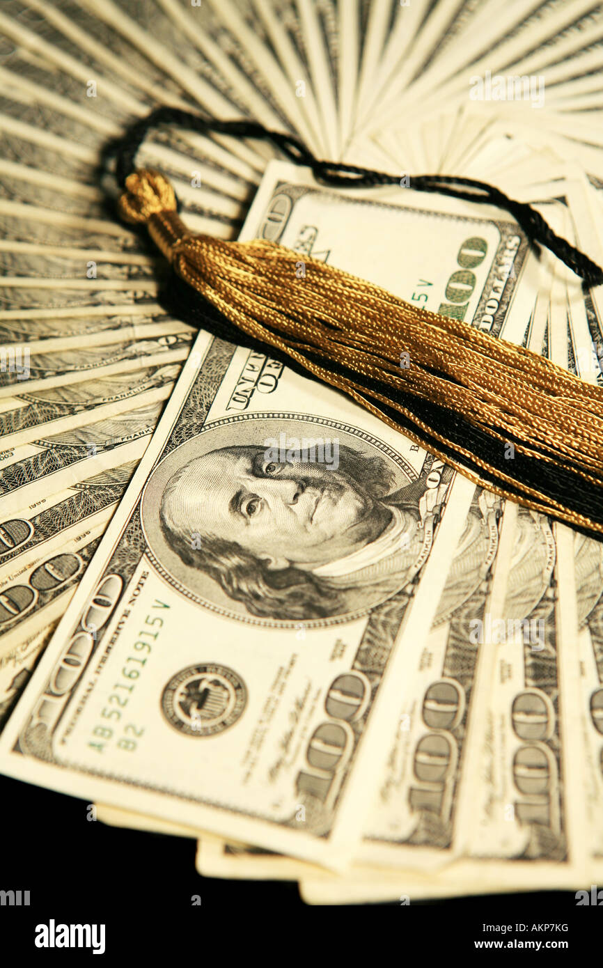 Black and gold graduation tassel on top of money Stock Photo - Alamy