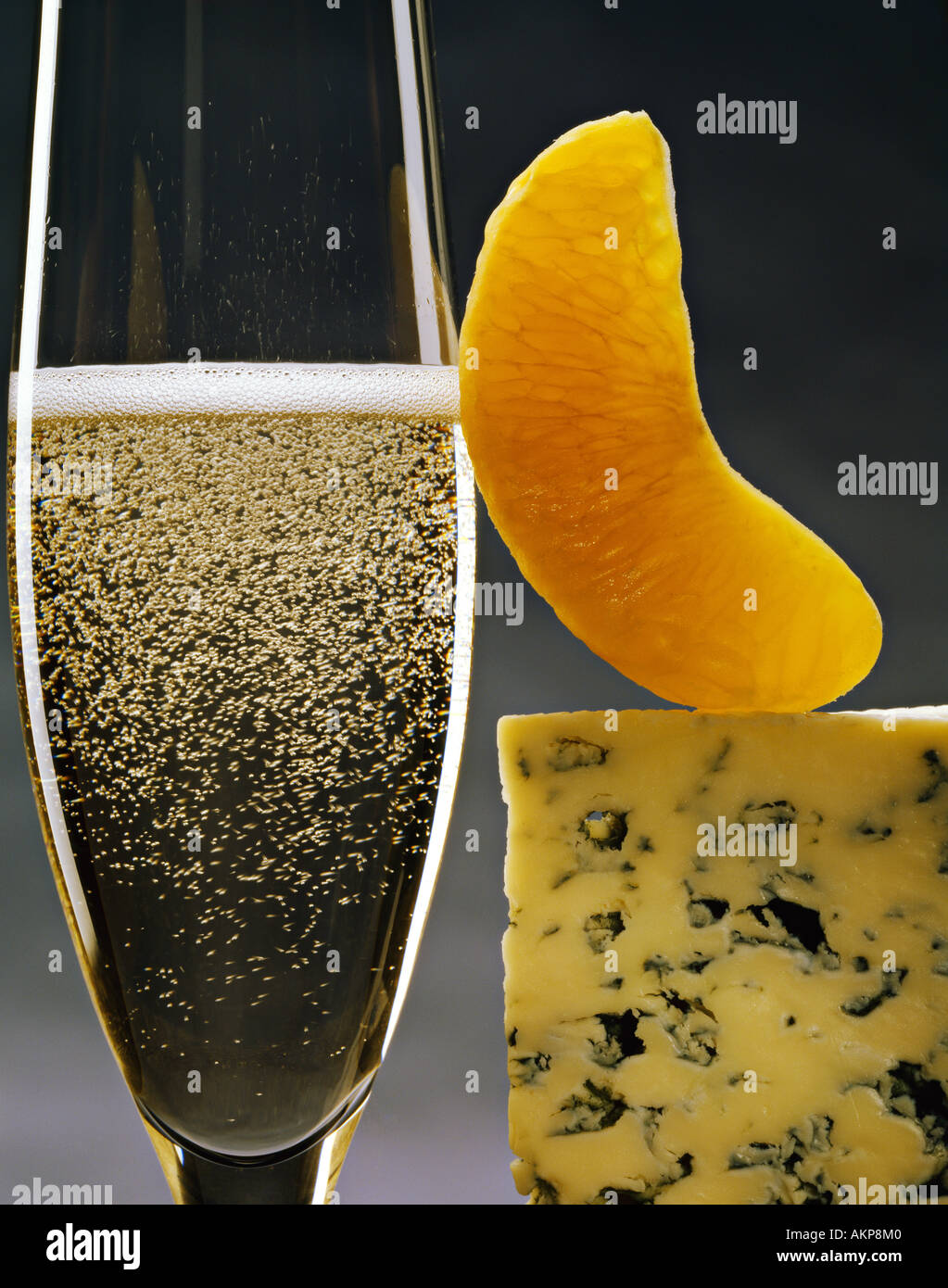 Champagne glass with orange slice and blue cheese Stock Photo