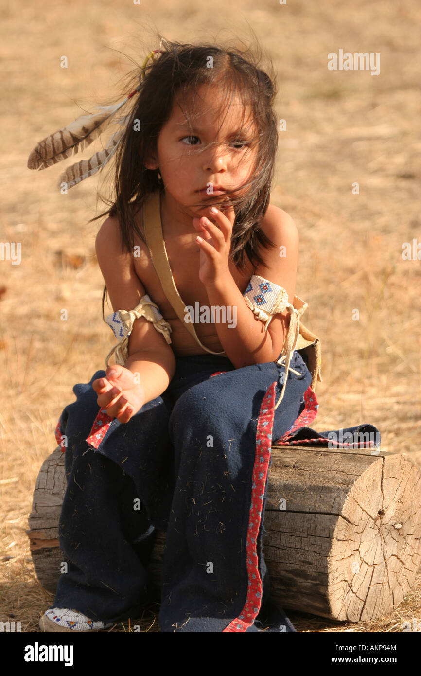 Young Native American Boy Sitting On A Log Looking Distraught Or Upset Stock Photo Alamy