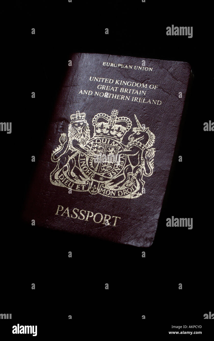 A tatty well used British passport bearing a European Union stamp serving as proof of identity and allowing the user to travel Stock Photo