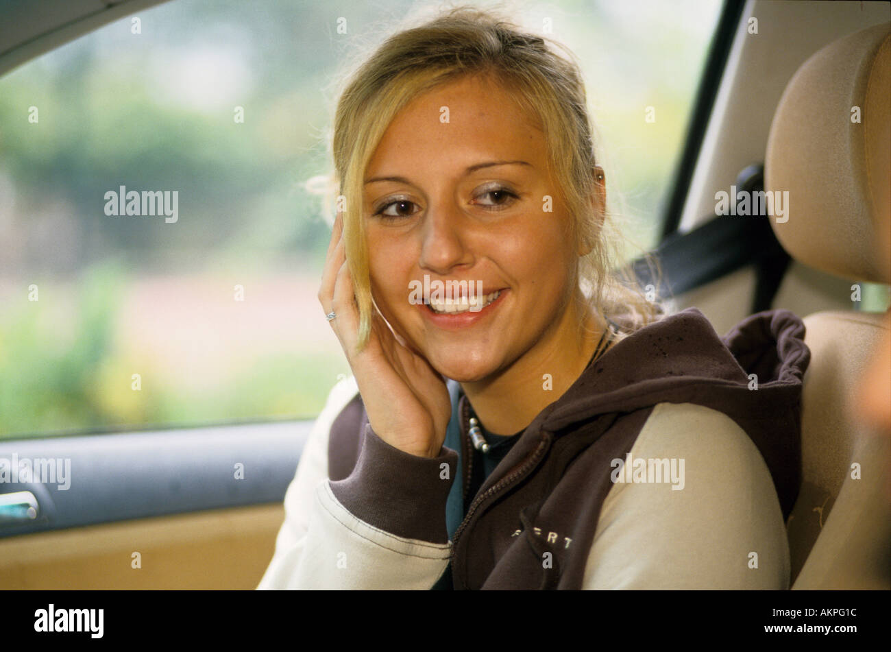 Germany Free time Portrait of a young woman sitting in a car  Stock Photo
