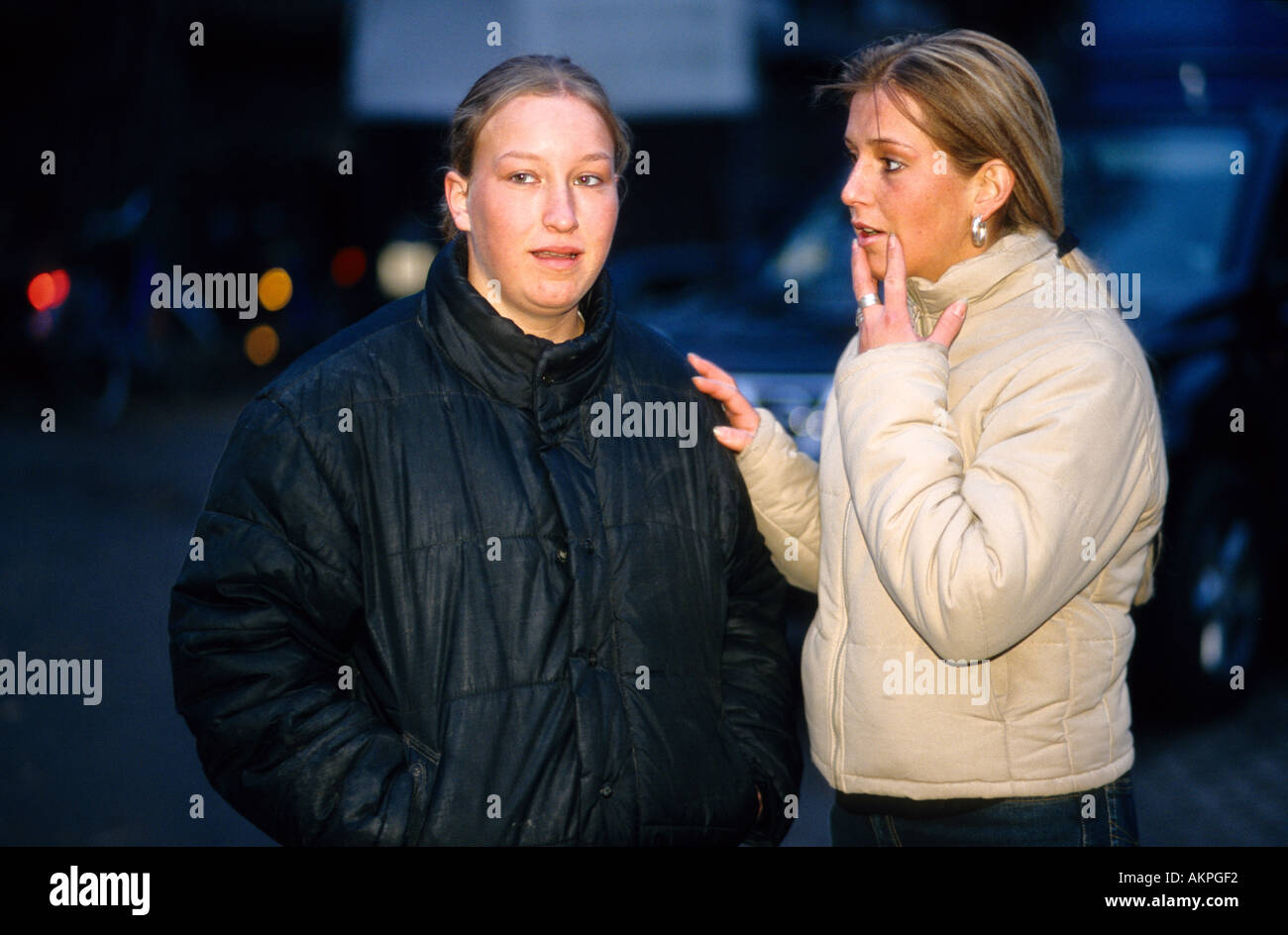 Germany Free time Portrait of two young women it seems that they are watching something  Stock Photo