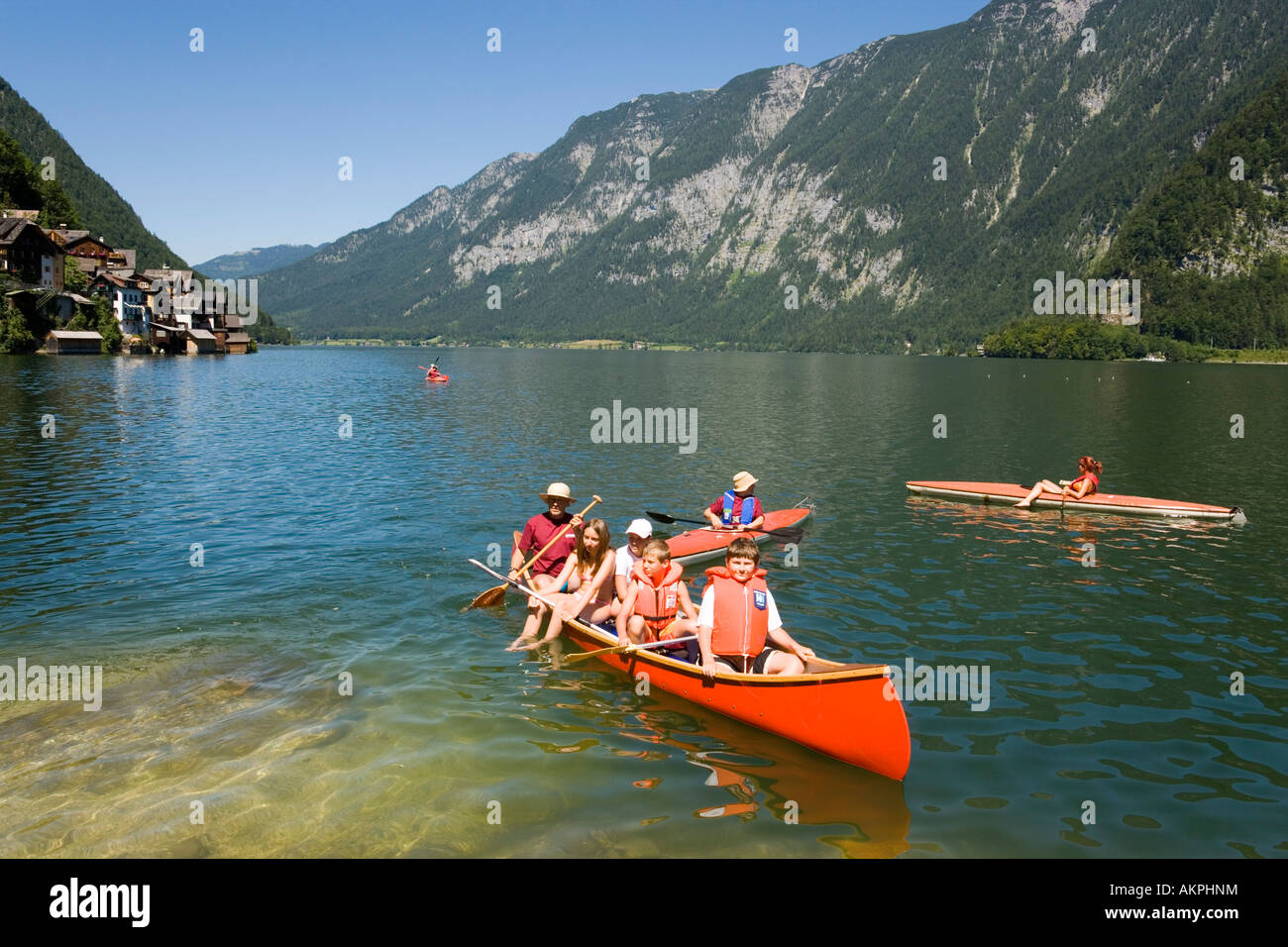 Children in a canoe lake Hallstatt Hallstatt Salzkammergut Upper Austria Austria Stock Photo