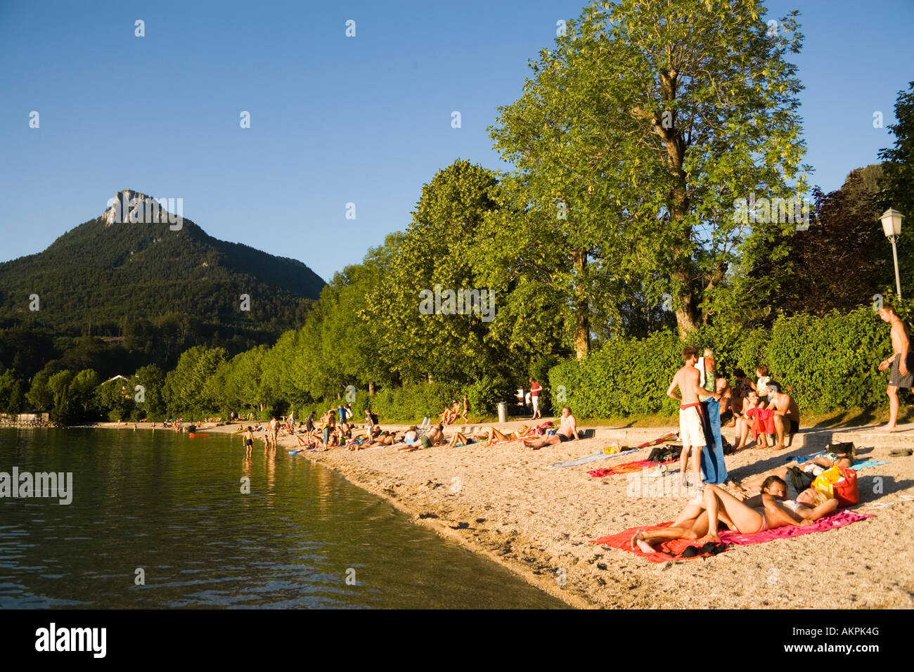 People relaxing at beach Lake Fuschl Fuschl am See Salzkammergut Salzburg Austria Stock Photo