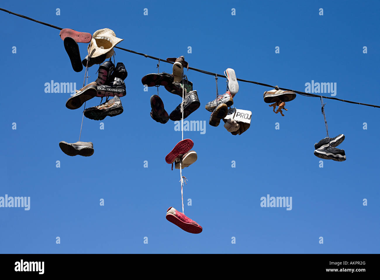 Shoes hanging from power line Stock Photo Alamy