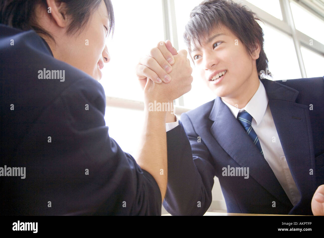 High school boy doing arm wrestle with friend Stock Photo Alamy