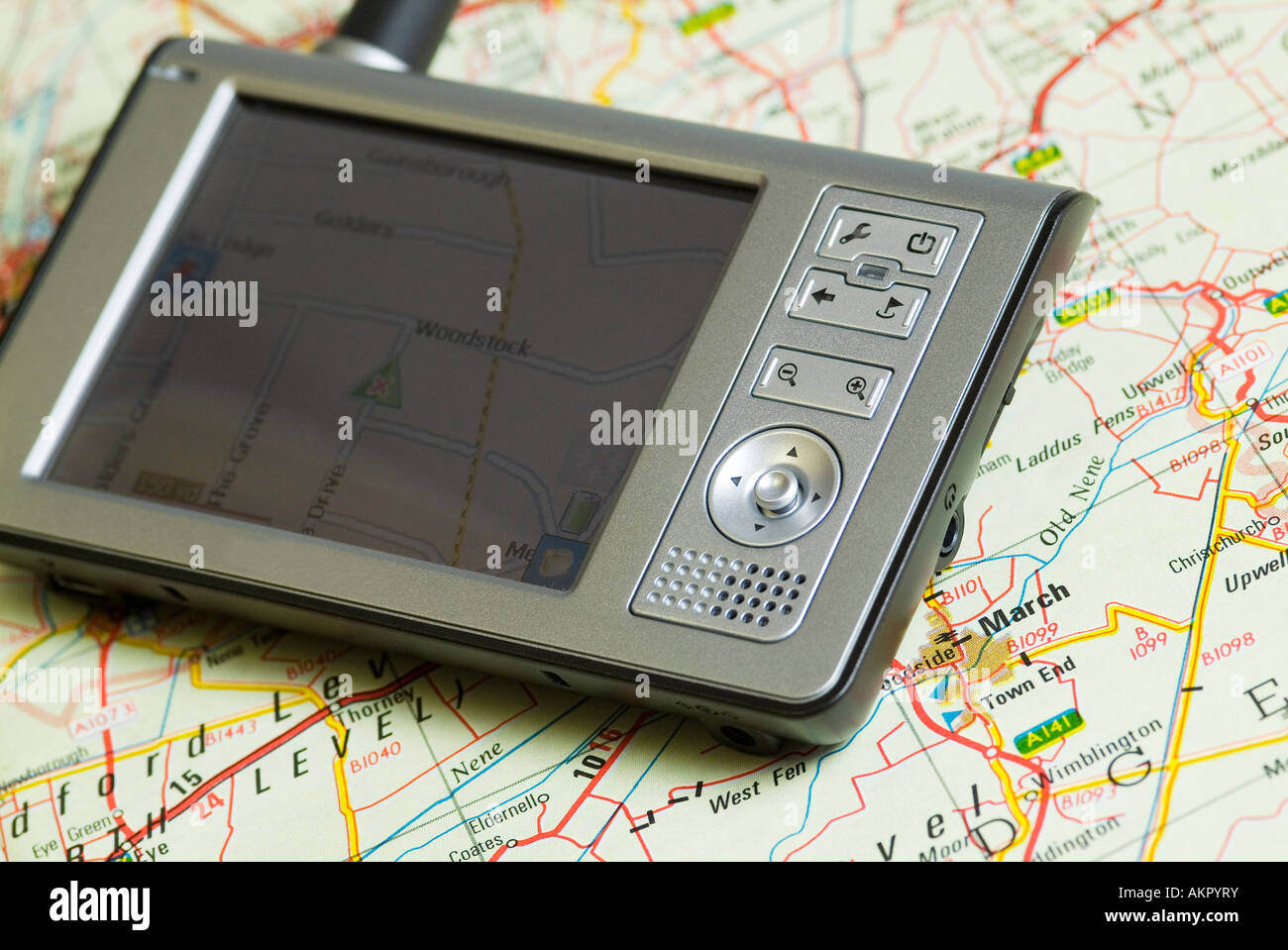 Personal navigation system resting on map, Sat nav Stock Photo