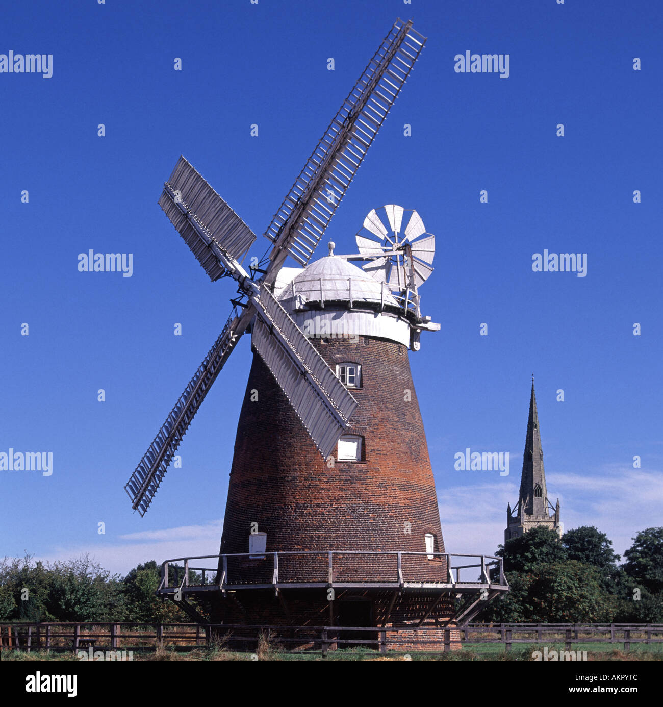 Historical John Webbs Lowes Mill a tower mill windmill of 1804 & church spire beyond both landmarks in English village of Thaxted  Essex England UK Stock Photo