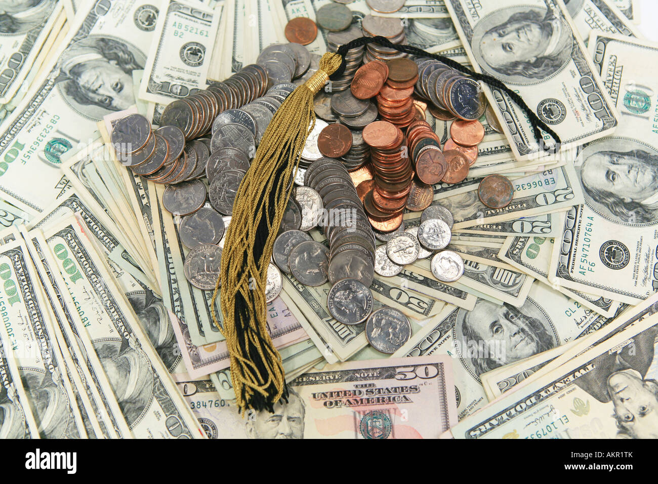 Black and gold graduation tassel on top of money Stock Photo - Alamy
