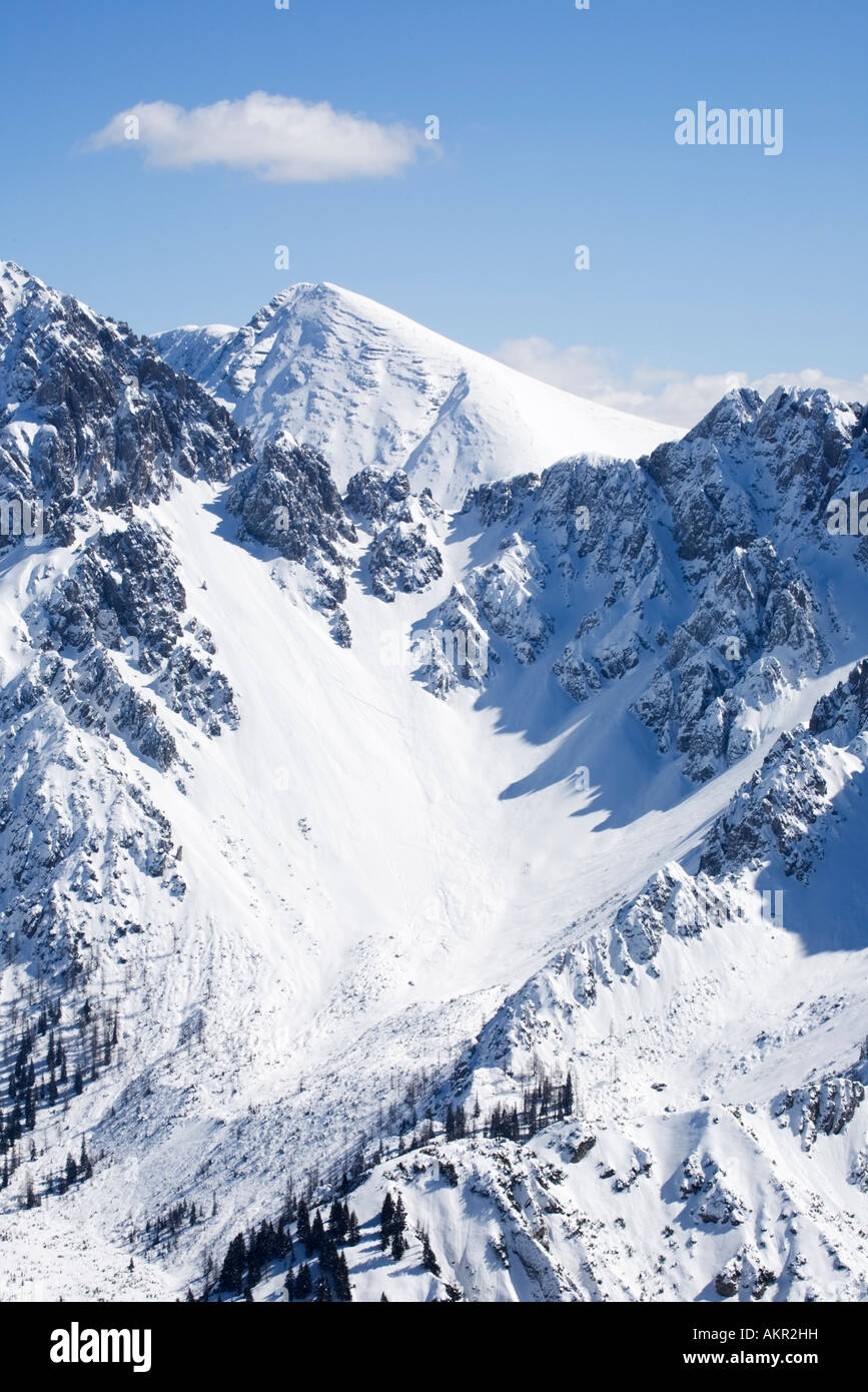 view from the top of a mountain in winter showing trails of cross country skiers Stock Photo